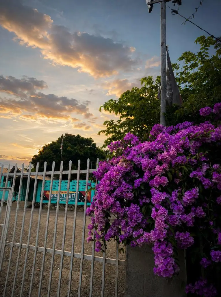 The gate of Wantok Radio Light at Gerehu Stage 2 at sunset